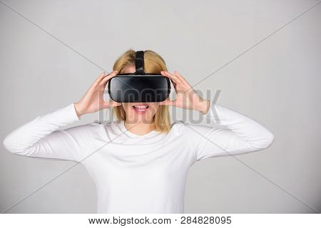 Woman Using Virtual Reality Headset. Woman Watching Virtual Reality Vision. Beautiful Woman Wearing 