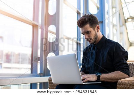 Man Skilled Entrepreneur Checking E-mail On Laptop Computer While Waiting Plane In Airport Terminal 