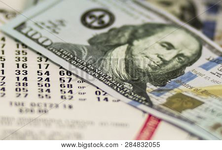 Lotto Tickets Are Covered With One Hyndred Dollar Bills.
