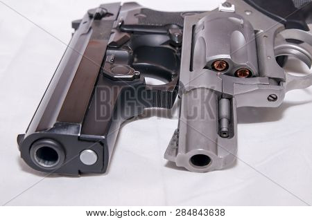 Two Handguns, A 40 Caliber Pistol And A 357 Magnum Revolver On A White Background