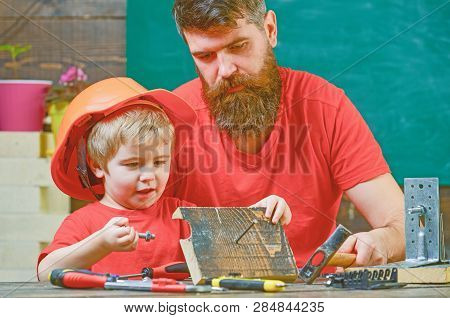 Father, Parent With Beard Teaching Little Son To Use Hobnails And Hammer. Masculine Duties Concept. 