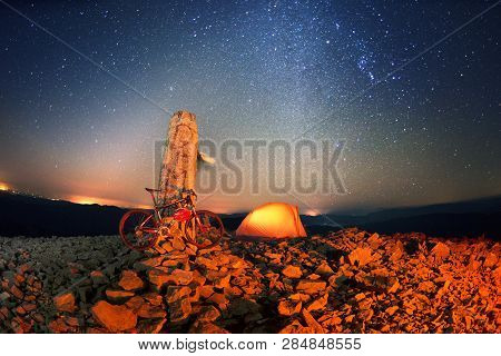 Bike On A Stone Pillar Tops At Night