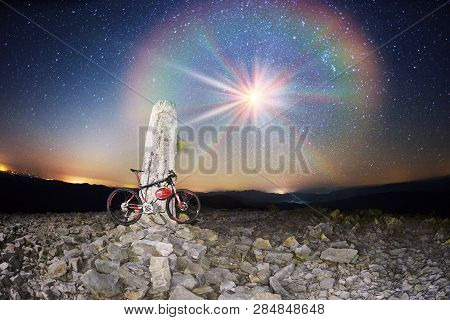 Bike On A Stone Pillar Tops At Night
