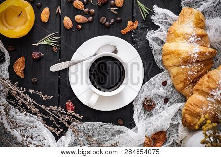 Cup Of Black Coffee And Croissants On Black Background, Top View. Flat Lay Of Espresso And Cornetto 