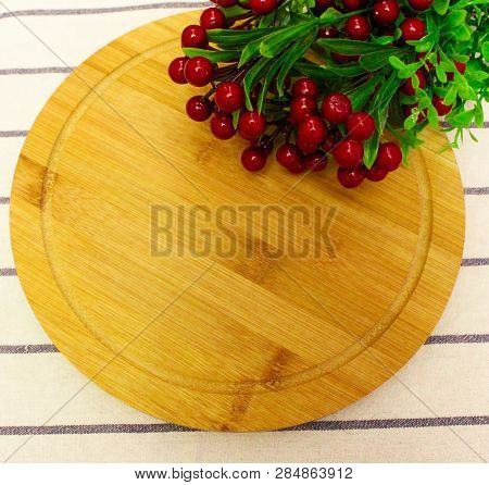 Red Round Berry, Green Leaves On Brown Round Chopping Board