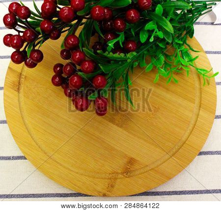 Red Round Berry, Green Leaves On Brown Round Chopping Board