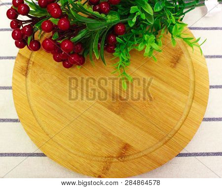 Red Round Berry, Green Leaves On Brown Round Chopping Board
