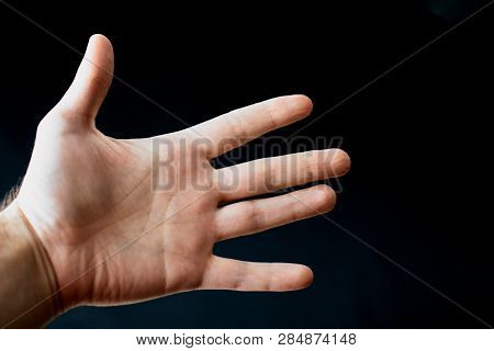 Adult Hand With Raynaud's Syndrome - Phenomenon. Close Up Hand With Fingers On Dark Background With 