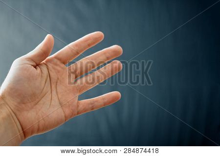 Adult Hand With Raynaud's Syndrome - Phenomenon. Close Up Hand With Fingers On Dark Background With 