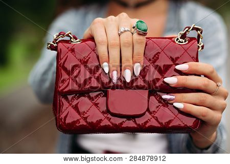 Trendy Woman With Beautiful Manicure Holding Red Handbag.