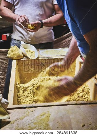 Cooks Making Dough For Tortillas On A Kneading Trough.