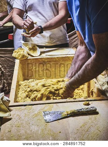Cooks Making Dough For Tortillas On A Kneading Trough.