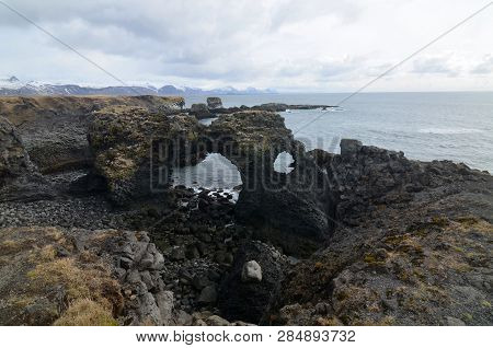 Arch Lava Rock Formation At Arnastapi In Iceland.