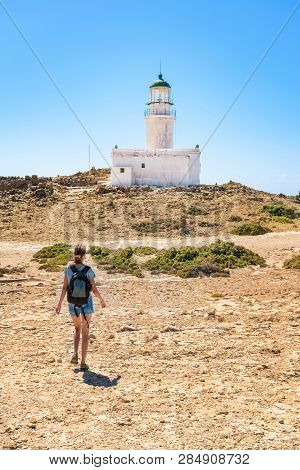 Girl Walking To White Lighthouse In Prasonisi National Park (rhodes, Greece)