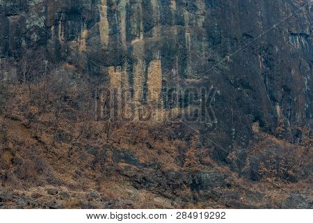 Closeup Of Jwasangbowi Rock, A Large Volcanic Rock In  Jangtan-ri, South Korea, In Background.