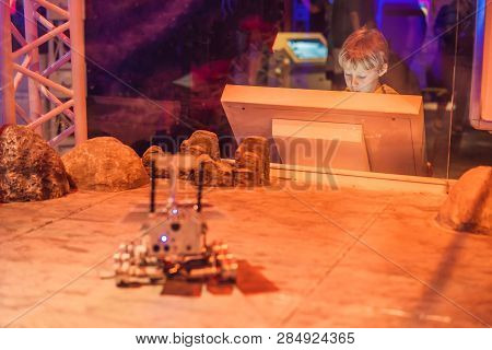 The Boy Controls The Toy Rover On Mars. Flight To Mars Concept