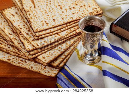 Passover Wine And Matzoh Jewish Holiday Bread Over Wooden Board.