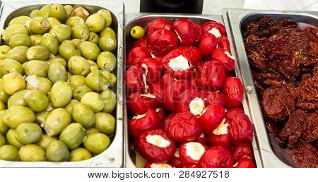 Assortment Variety Of Handmade Artisan Marinated Brine Cured Antipasti Tapas Green Olives With Herbs