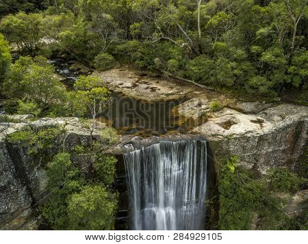 Bushland Creek Falls Into A Majestic Waterfall In Southern Highlands Australia