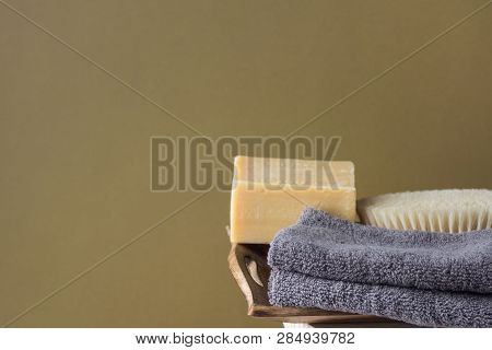 Hand Crafted Artisan Olive Oil Soap Body Brush Folded Cotton Towels Stacked In Wooden Tray On Chair 
