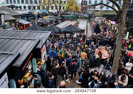 LONDON, UK - DECEMBER 30, 2018: Visitors at Camden Lock. Camden Lock, Camden Market, and streets nearby are the fourth-most popular attraction in the city, attracting 100,000 people each weekend