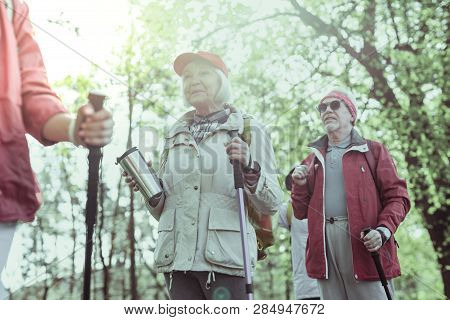 Couple Of Seniors Hiking Using The Special Staff