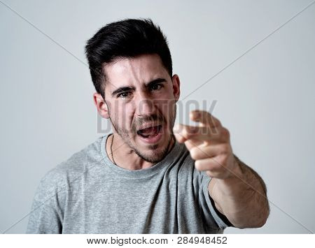 Close Up Portrait Of Young Violent Man With Angry Face Looking Furious And Crazy Showing Fits And Po