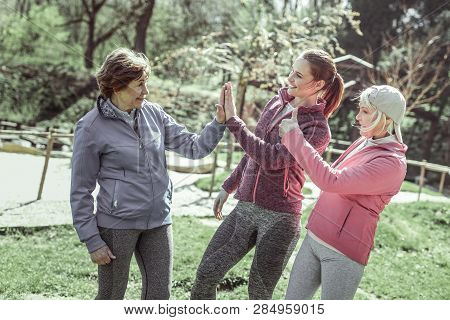 Girls In Sportive Uniforms Giving Five Each Other