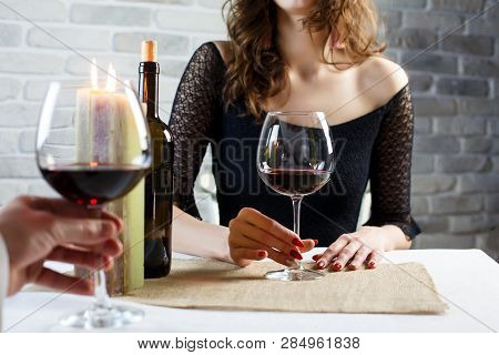 Young Woman Is Flirting On A Blind Date With A Man In A Restaurant. The Couple Is Sitting At The Tab