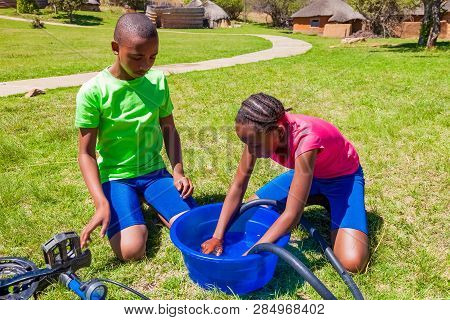 African Children Fixing A Puncture On A Bike