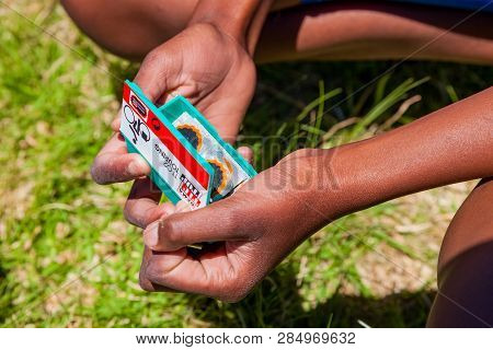 African Children Fixing A Puncture On A Bike