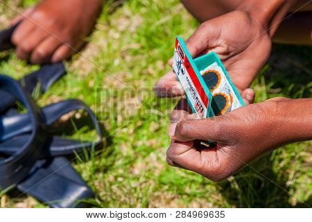 African Children Fixing A Puncture On A Bike