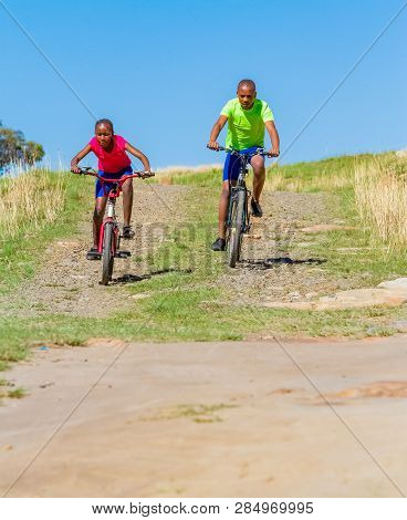 African Children Riding A Bike In Rural A Village