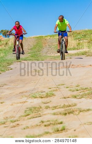 African Children Riding A Bike In Rural A Village