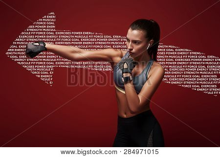 It Never Gets Easier. You Just Get Strong. Attractive Sportswoman Doing Kickboxing Exercises  Over R