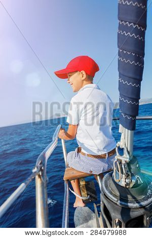 Little Boy On Board Of Sailing Yacht On Summer Cruise. Travel Adventure, Yachting With Child On Fami