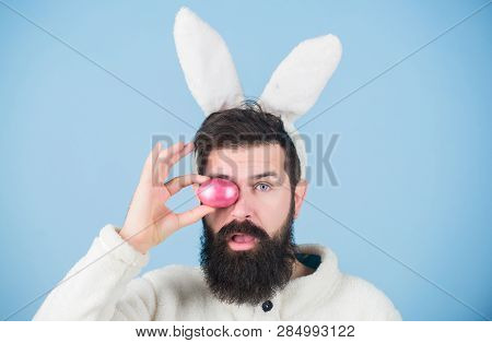 Having Fun. Funny Bunny With Beard And Mustache Hold Pink Egg. Bearded Man Wear Silly Bunny Ears. Ea