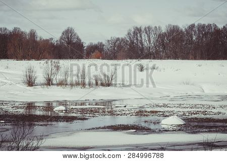 White snow on a small river in Russia in winter