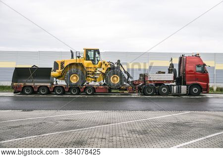 A Truck With A Special Semi-trailer For Transporting Oversized Loads. Transport Of A Huge Bulldozer.