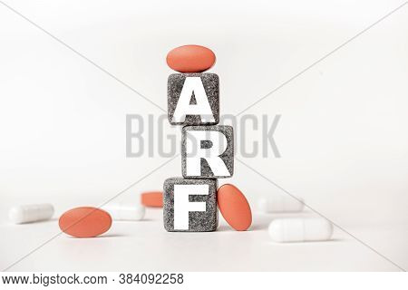 A Group Of White And Red Pills And Cubes With The Word Arf Acute Renal Kidney Failure On Them, White