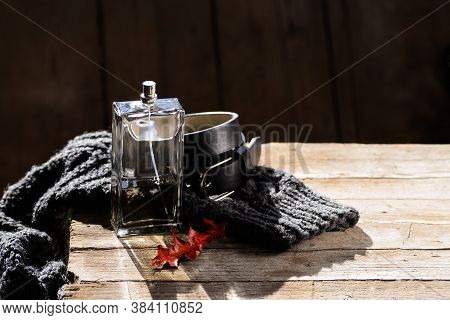 Men's Perfume In A Transparent Despenser, A Leather Black Belt Lie On A Woolen Knitted Men's Sweater