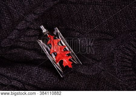 Transparent Bottle, Spray With Men's Perfume And Autumn Red Leaf, Elegantly Beautifully Lies On A Wa