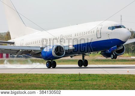Airplane Landing On Runway. Touchdown With Tire Smoke