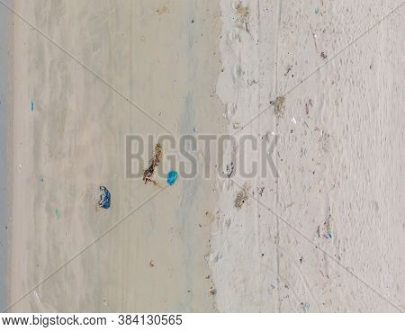Sandy Beach With Plastic Garbage And Medical Waste Materials In Tropical Beach With Emerald Clear Se