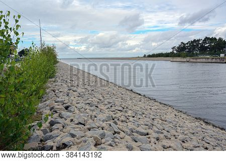 Industrial Port Lubmin With Fairway And Quay Under A Cloudy Sky, Here Is The Landfall Of The Natural