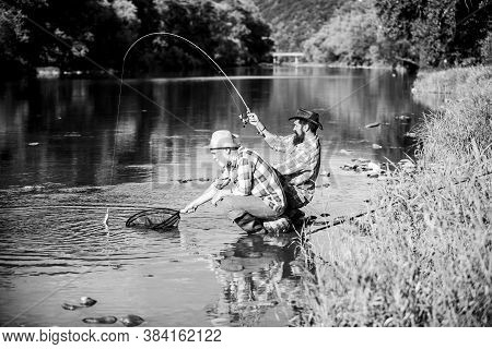 Spinnerbait. Fly Fish Hobby Of Men In Checkered Shirt. Retirement Fishery. Happy Fishermen Friendshi