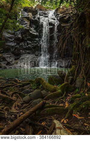 Tropical Landscape. Beautiful Hidden Waterfall In Rainforest. Adventure And Travel Concept. Nature B