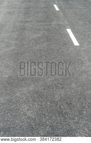 Dark Gray Asphalt With White Road Marking Lines. Abstract Background. Copspace