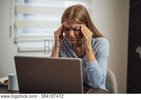 Young Modern Woman Is Working From Home. She Is Having Headache.