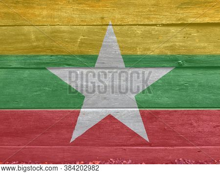Flag Of Myanmar On Wooden Wall Background. Grunge Myanmarese Flag Texture, Red Green And Yellow Colo